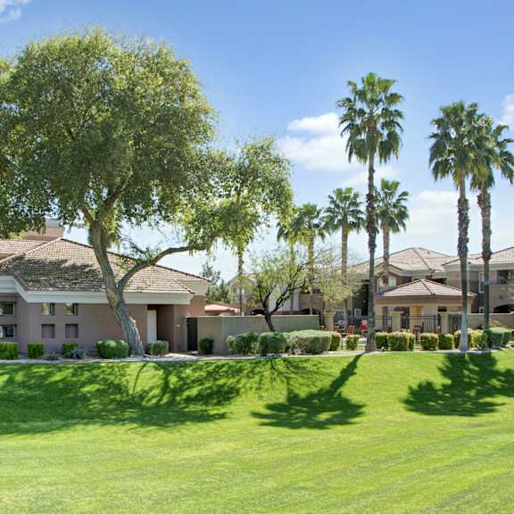 The exterior and green space at Desert Horizon Apartments. 