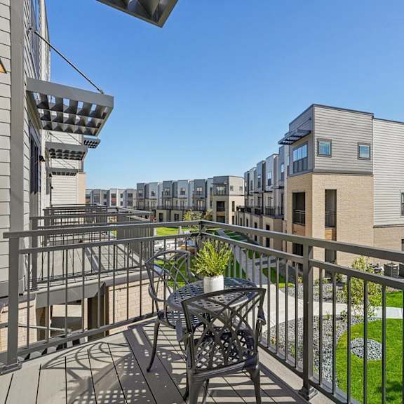 A balcony with a table and chairs at Meridian at CityPlace, Woodbury, MN 55125