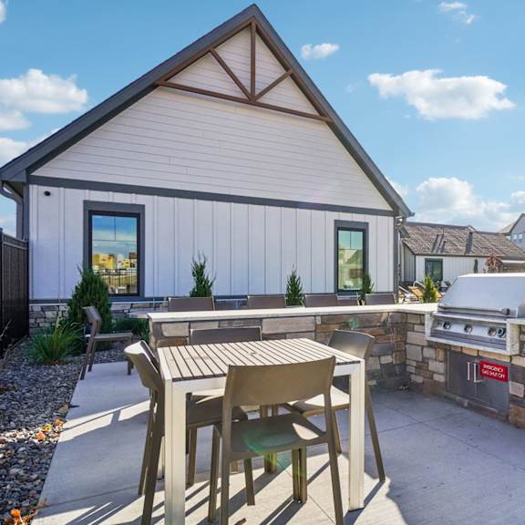 A patio with a table and chairs at Premier at West Park, Greeley, 80634