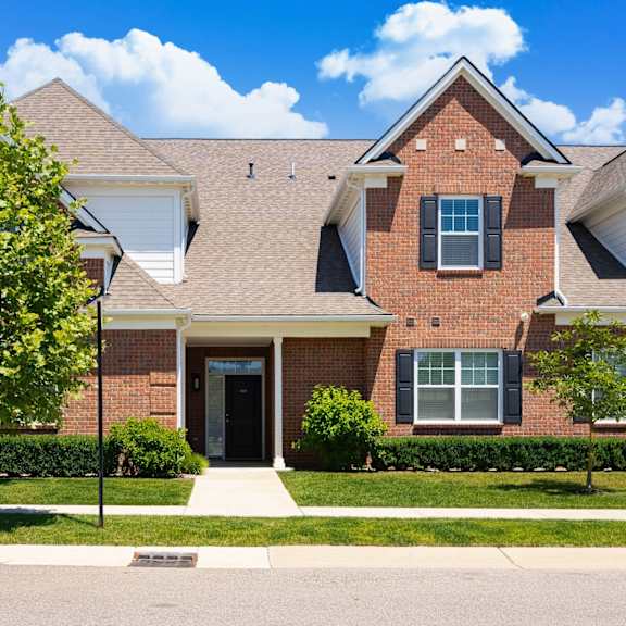A red brick house with a black door and windows.
