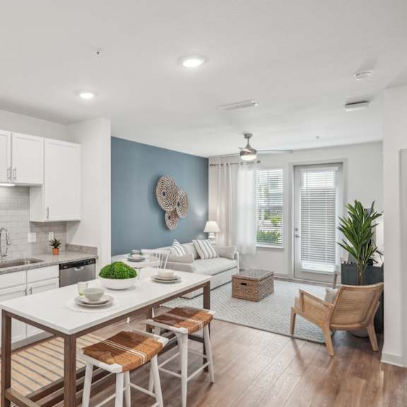 a kitchen and living room with a table and chairs