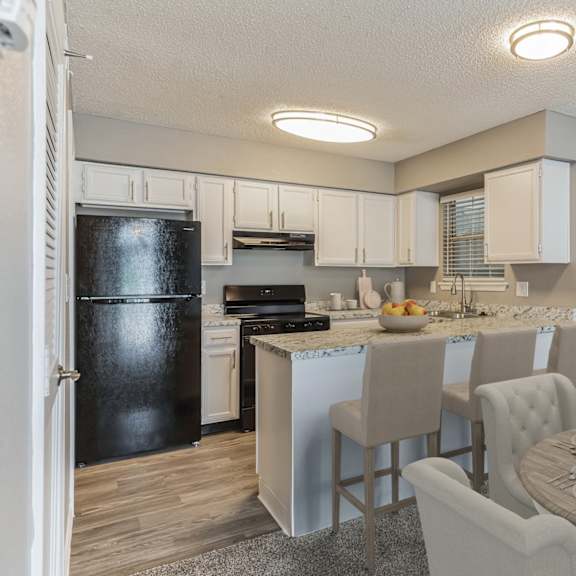 A kitchen with a dining table set for two.