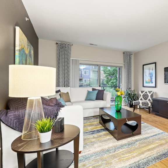 an open concept living room and dining area with a white dining table and rattan chairs