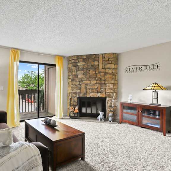 an open concept living room and dining area with a white dining table and rattan chairs