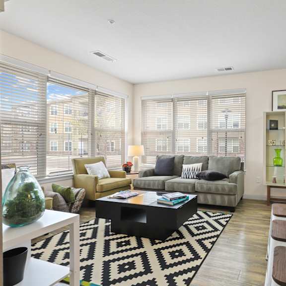 an open concept living room and dining area with a white dining table and rattan chairs