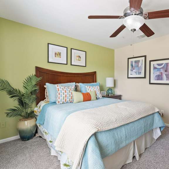 an open concept living room and dining area with a white dining table and rattan chairs
