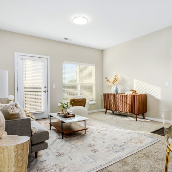 a living room with a couch and chairs and a table