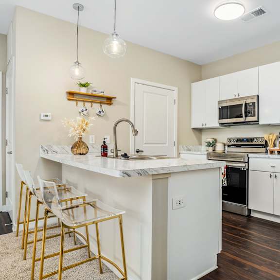 a kitchen with white cabinets and a white counter top