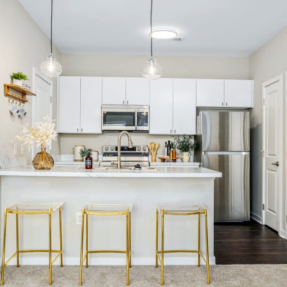 a kitchen with white cabinets and a white counter top
