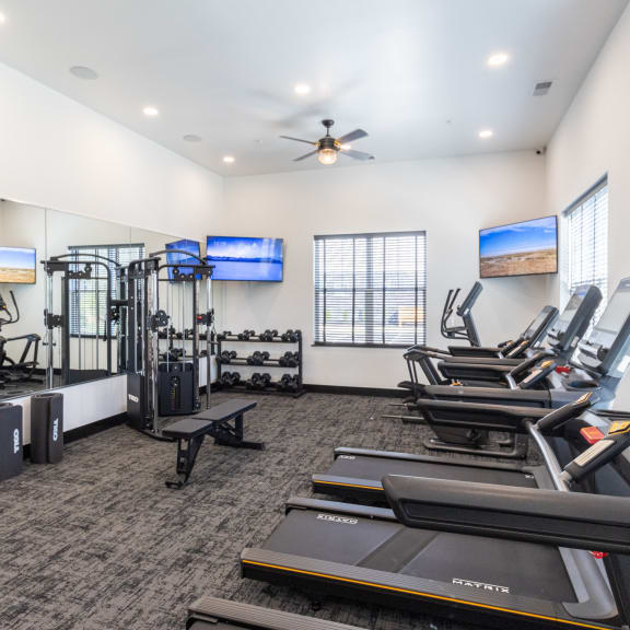 the gym with treadmills and cardio equipment at the belgard apartments