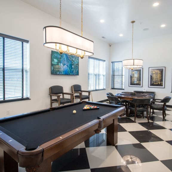 a games room with a pool table and a table and chairs