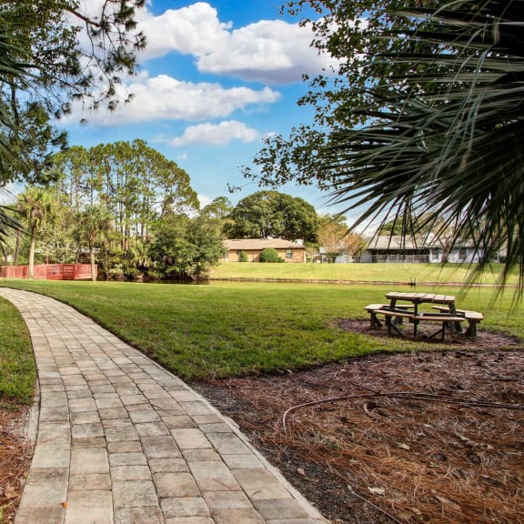 a stone path leads to a picnic table in a park at Timberwalk at Mandarin, Jacksonville, Florida