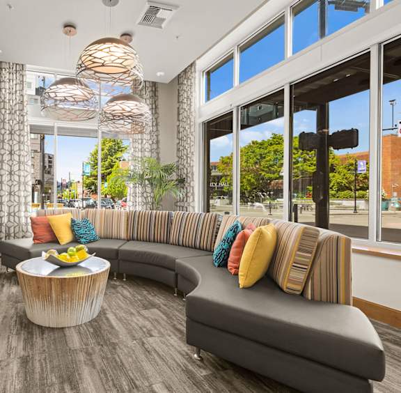 A modern living room with a grey sofa and a wooden coffee table.