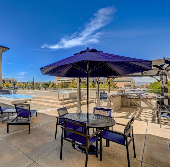 our apartments have a large patio with tables and chairs and a pool