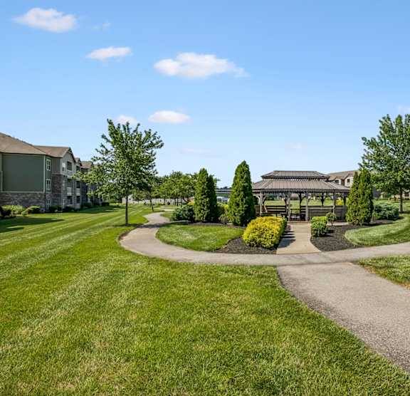 A pathway leads to a building with a courtyard in front.