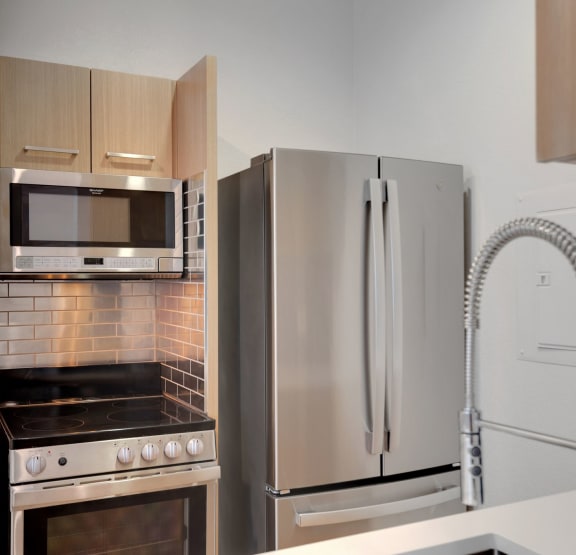 a kitchen with stainless steel appliances and a refrigerator