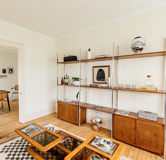 a bedroom with a bed and bookshelves     and a chair