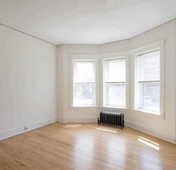 a bedroom with a bed and bookshelves     and a chair