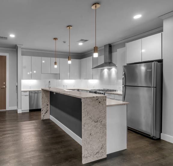 a kitchen with white cabinets and stainless steel appliances  at Nineteen North, Buffalo, NY