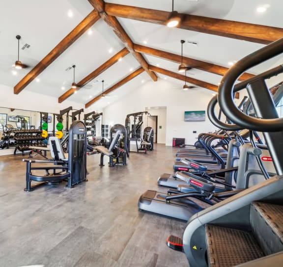 the gym with cardio equipment and weights at the resort on long island