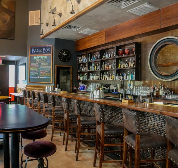 a bartender standing in front of a bar
