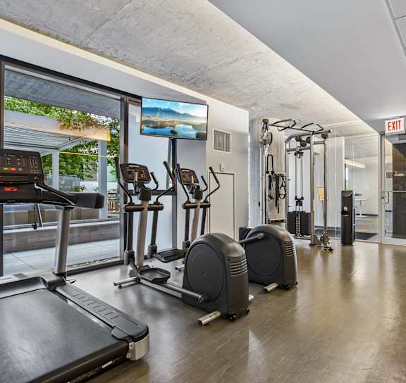 A gym with treadmills, elliptical machines and other cardio equipment.