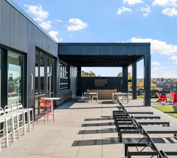 a large kitchen with white cabinets and stainless steel appliances and a large window with a view of