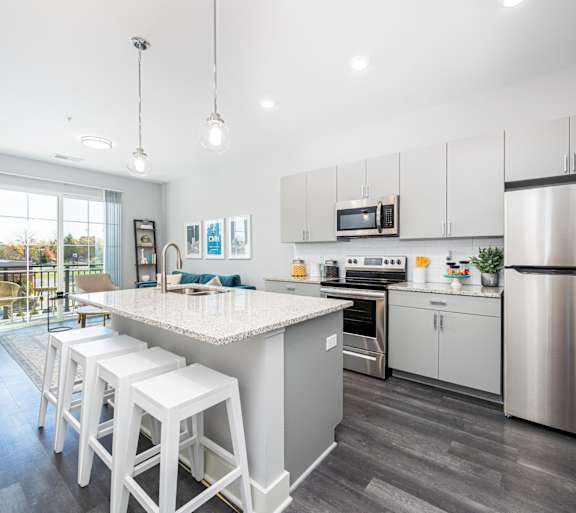 a kitchen with stainless steel appliances and a marble counter top
