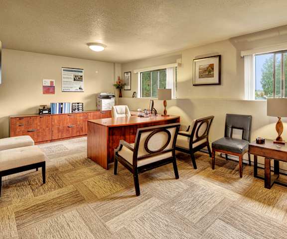 The leasing office with a desk and chairs at Deer Park Apartments. 