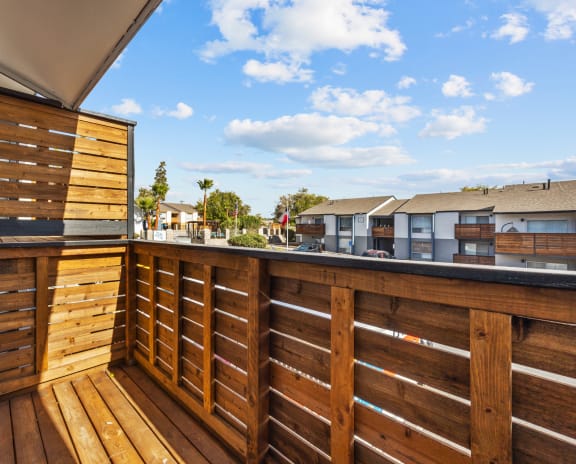 the deck has a privacy fence and a view of the neighborhood