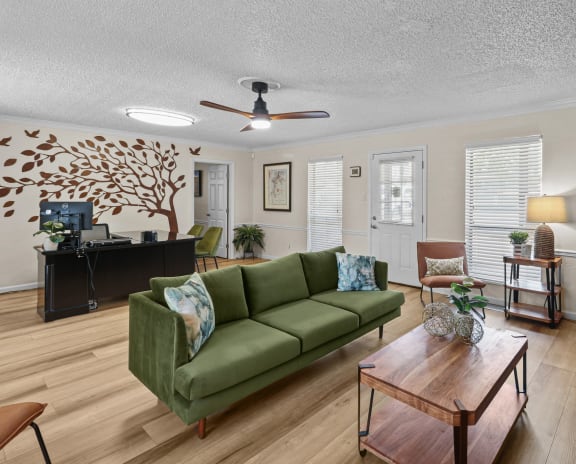 a living room with a green couch and a coffee table