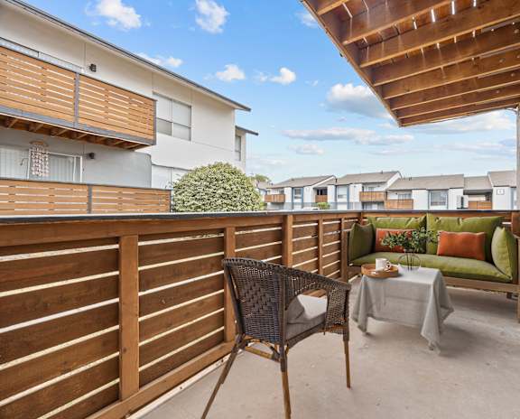 the deck has a privacy fence and a view of the neighborhood