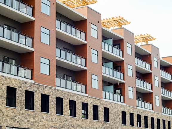 A multi-story building with balconies and windows.