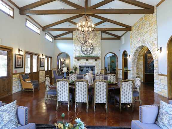 A large room with a fireplace and a chandelier.