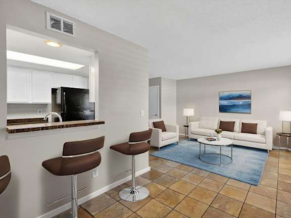 A living room with a bar area and a couch.