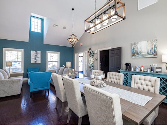 A dining room with a long table and chairs.