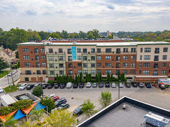 A large multi-story building with a parking lot in front.