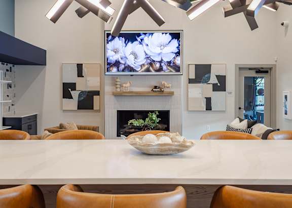 A modern dining room with a large table and chairs.