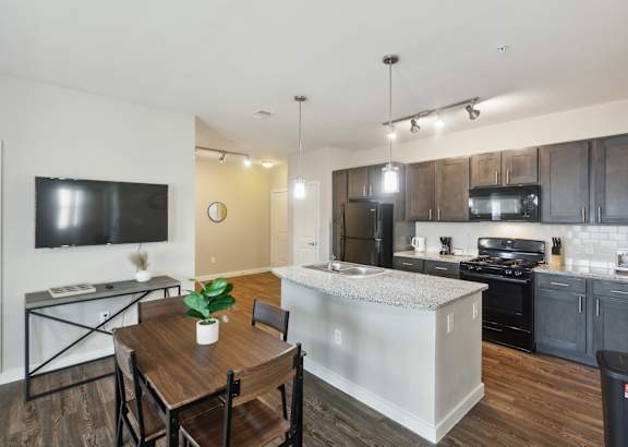 a kitchen with white cabinets and a granite counter top