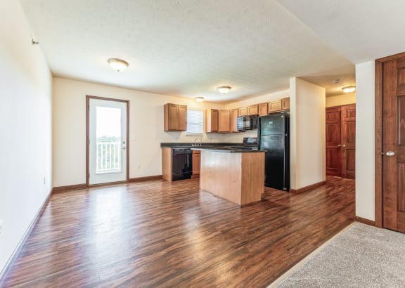 a kitchen with white cabinets and a granite counter top