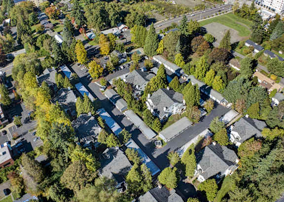 an aerial view of a neighborhood with houses and trees