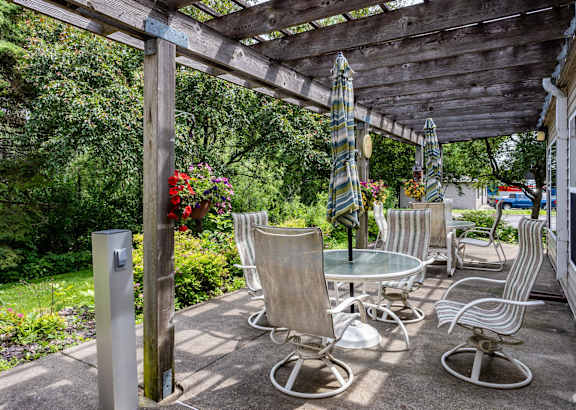 a patio with chairs and tables and umbrellas