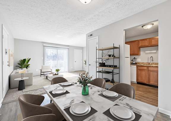 A dining room with a table set for four.