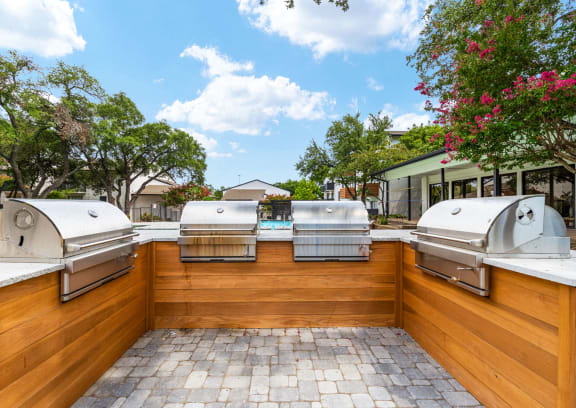 a patio with a grill and a swimming pool
