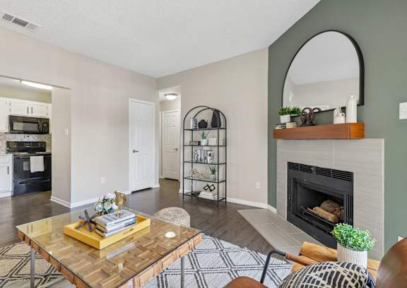 A living room with a fireplace and a coffee table.