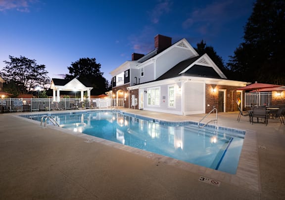 a swimming pool with a house in the background