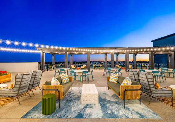 A patio with a lot of furniture and a blue sky.