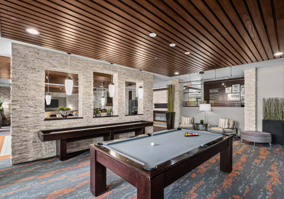 a clubhouse with a pool table and a living room