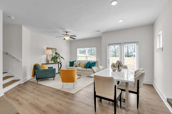 A living room with a white dining table and chairs.