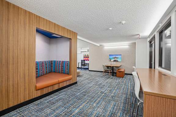 A room with a blue carpet and wooden walls.